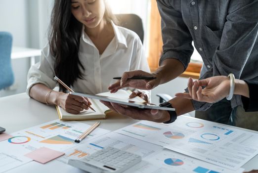 business partnership coworkers discussing a financial planning graph and company during a budget meeting in office room. business financial accounting concept