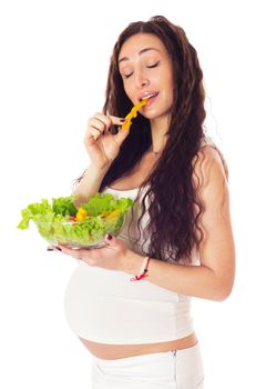 Pregnant woman eating chopped salad, isolated on white.