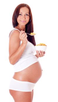 Pregnant woman eating corn flakes, isolated on white.