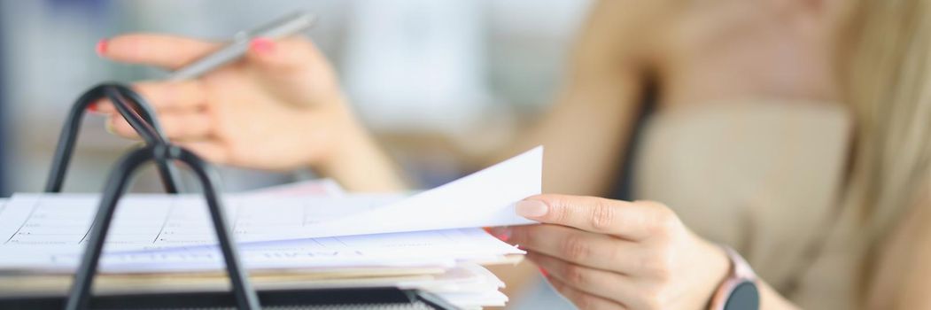 Close-up of female busy with papers on workplace, documents and problem projects, day in hurry. Clever company worker in office. Business, success concept