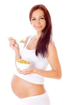 Pregnant woman eating corn flakes, isolated on white.