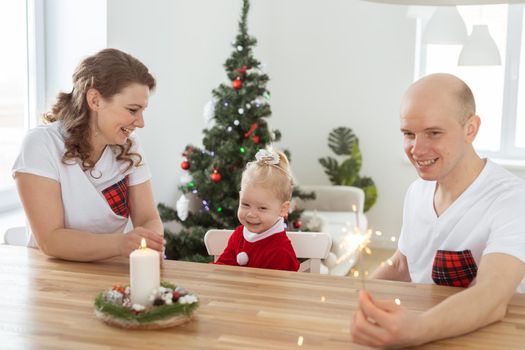 Child girl dressed in christmas dress with cochlear implants having fun at home - hearing aid and innovating technologies for treatment deafness