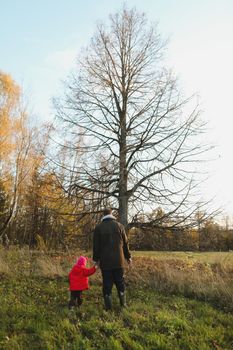 Happy father and child spending time outdoors. father with daughter in autumn park.