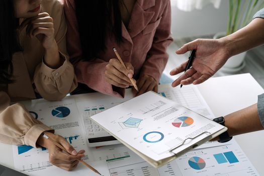 Asian business adviser meeting to analyze and discuss the situation on the financial report in the meeting room.Investment Consultant, Financial advisor and accounting concept.
