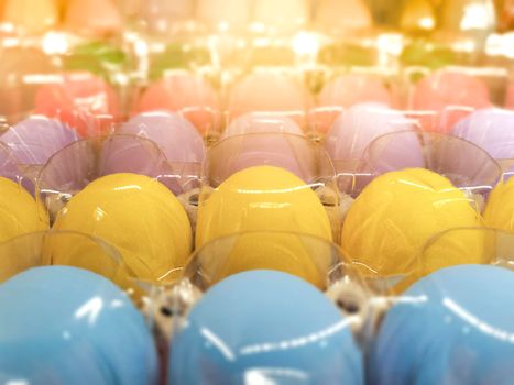 Close up Many colorful eggs fresh from farm pack up in recycle egg tray covered with transparent plastic .