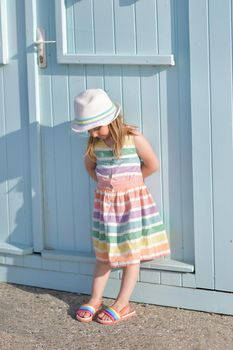 Girl in a colored dress near wooden houses on the ocean Saint aubin sur mer