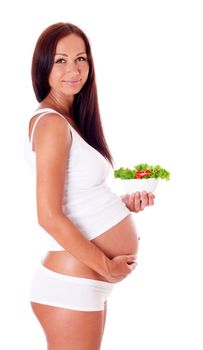 Pregnant woman eating chopped salad, isolated on white