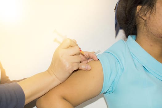 close up The nurse giving a vaccine covid-19 for a patient.