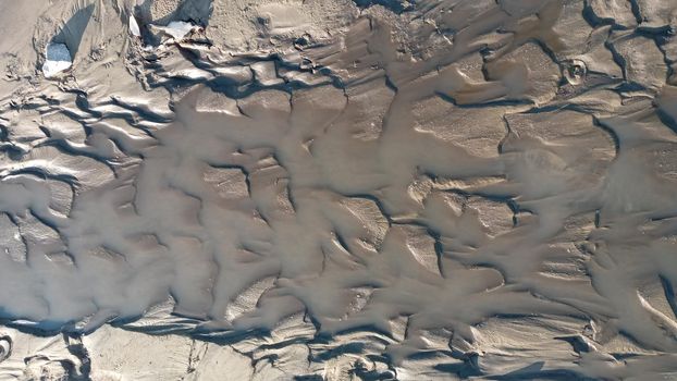 Dirty wet sand, grunge horizontal shabby background close-up. Blurry image of sand pattern. Abstract nature background.