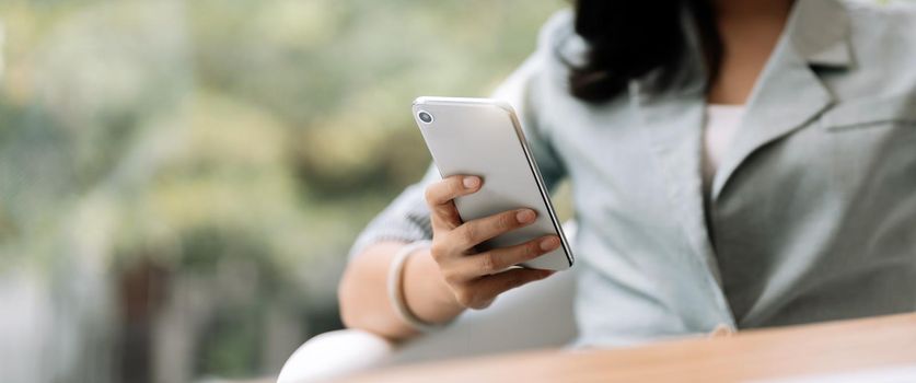 Close up business woman using smart phone, chatting social media