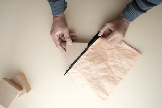 top view of person putting a gift box in a bag ,