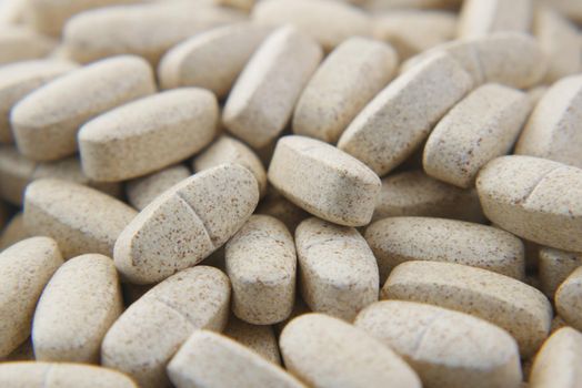 white color medical pills spilling on pink ,
