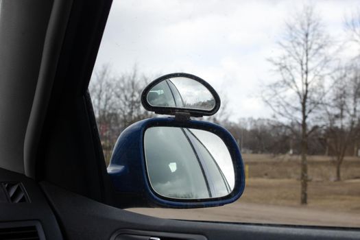 Road and cars in the side mirror of a car