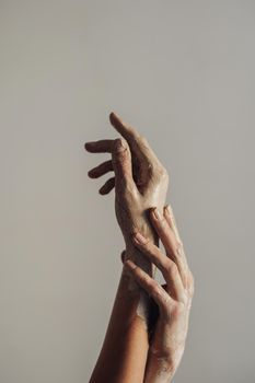 Female Hands Greased in Clay on Background of Light Gray Wall, Art Work Concept