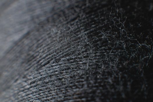 Black thread spool in macro extreme close-up. clothing industry.