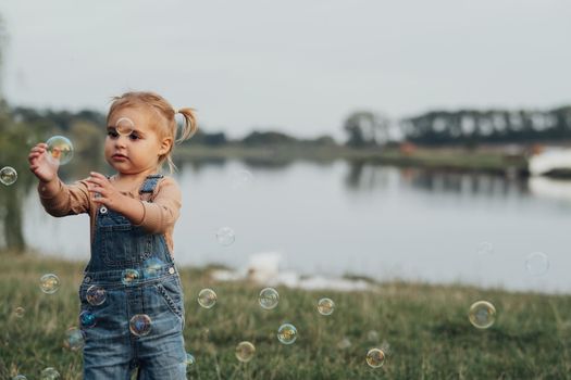 Little Girl Playing with Bubbles Outdoors, Kid Having Fun Time Open Air