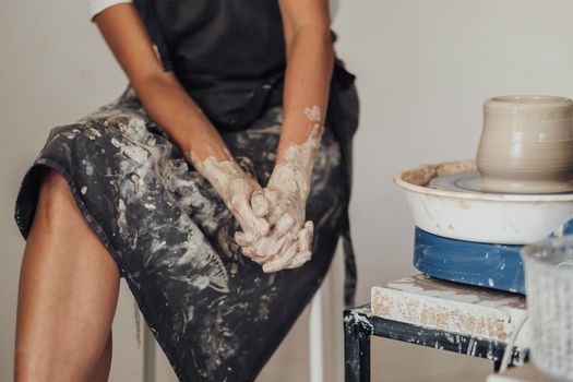 Unrecognisable Potter Sitting Near Pottery Wheel in Studio, Female Potter Artist at Work