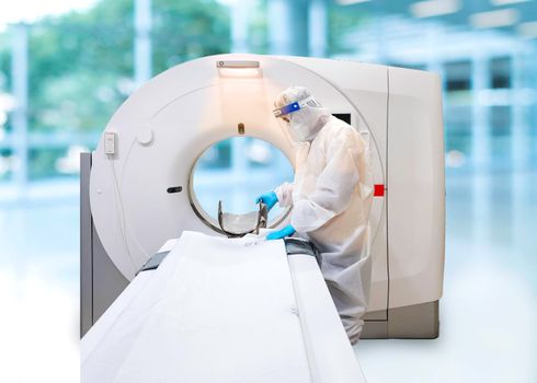 Medical staff wearing PPE suit with face shield, medical mask and medical grove for protect coronavirus covid-19 virus before scan patient in CT scan room