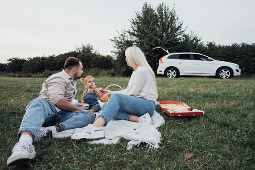 Family Picnic Time, Young Parents with Their Little Daughter Enjoying Weekend Outdoors, Road Trip on SUV Car