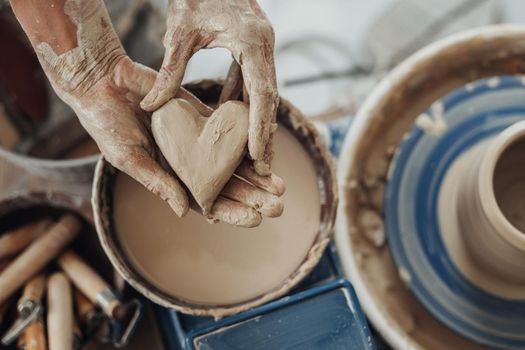 Pottery Master Holding Heart Crafted from Clay, Handmade Work