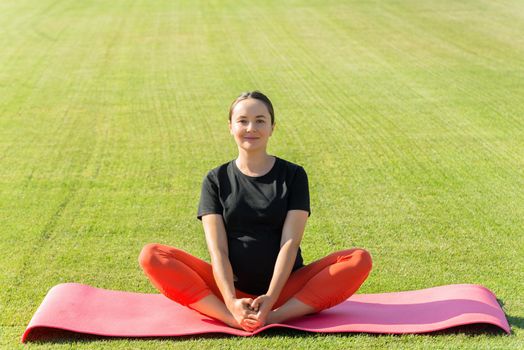 pregnant woman performs yoga asanas. High quality photo