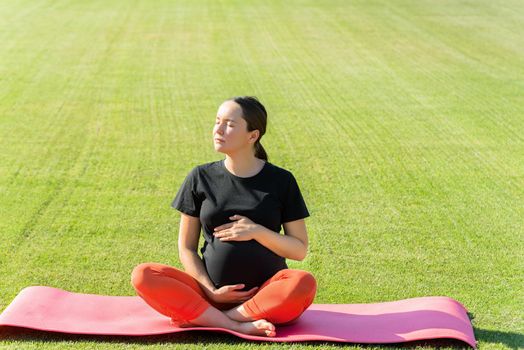 pregnant woman performs yoga asanas. High quality photo