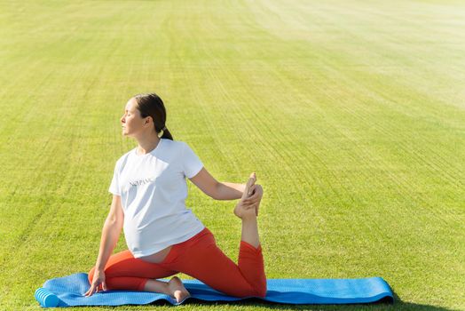 pregnant woman performs yoga asanas. High quality photo