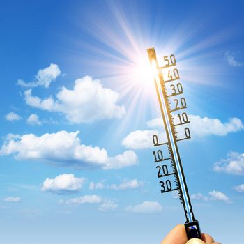 Mercury thermometer. Summer heat or global warming climate change concept.