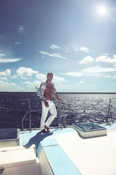 Man enjoying summer time holiday on sailing boat.