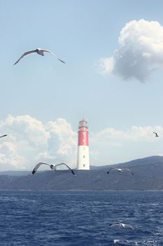 Beautiful summer seascape with lighthouse and sky