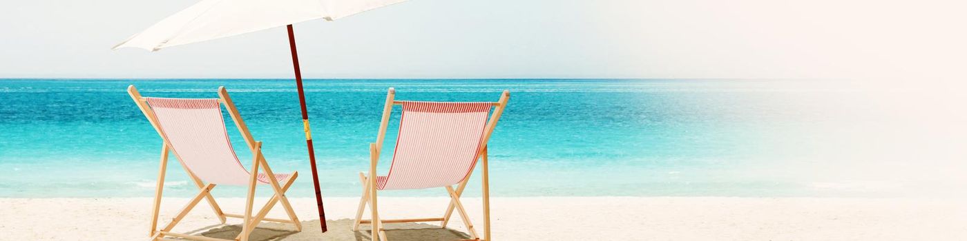 Wooden deck chairs on sandy beach near sea. Holiday background.