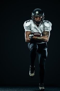 American Football player on stadium with smoke and lights.