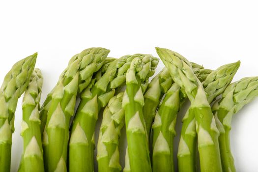 Fresh green asparagus on a white isolated background. Green asparagus isolate with shadow on white background