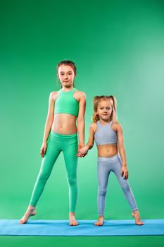 Kid doing fitness exercises at home in her room