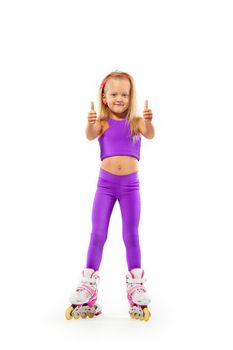 Daughter, posing in studio wearing inline roller skates.