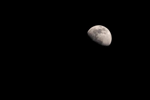 Convex waning moon over black sky