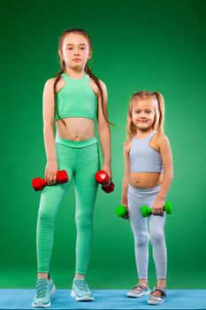 Kid doing fitness exercises at home in her room