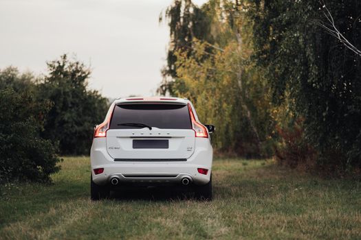TERNOPIL, Ukraine - September 11 2021: Back View of SUV Car Volvo XC60 Standing on Ground of Nature Park Open Air
