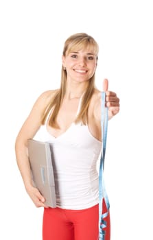 Fit young woman holding a scale, isolated on white