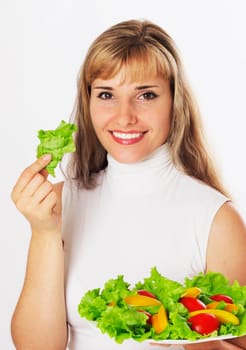 Happy young woman holding boul of salad and smiling big, isolated on white.