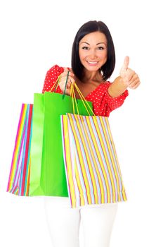 Portrait of beautiful brunette girl with paper bags going shopping and showing ok sign, isolated on white background.