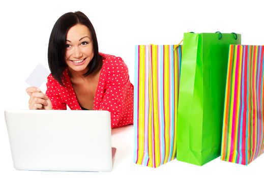 Beautiful woman contemplates her online purchase. Isolated on white.