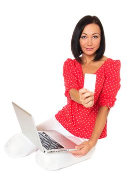 Beautiful woman contemplates her online purchase. Isolated on white.