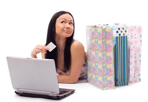 Beautiful woman contemplates her online purchase. Isolated on white.