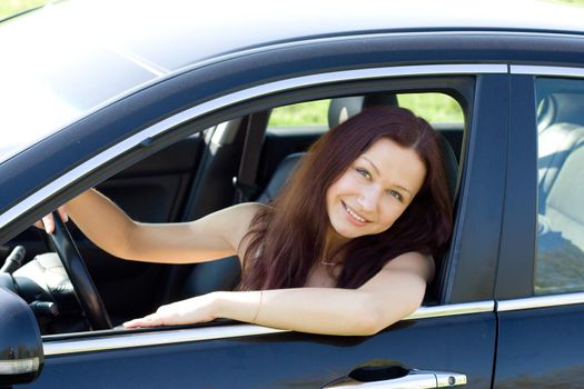 young woman smile in her new car