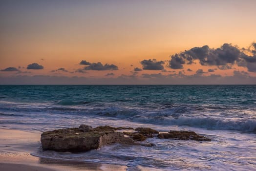 Sunset on the Caribbean Sea. Clear sky with small clouds. Clear weather.