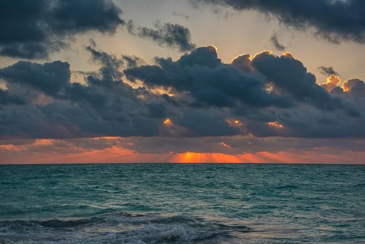 Sunset on the Caribbean Sea. Clear sky with small clouds. Clear weather.