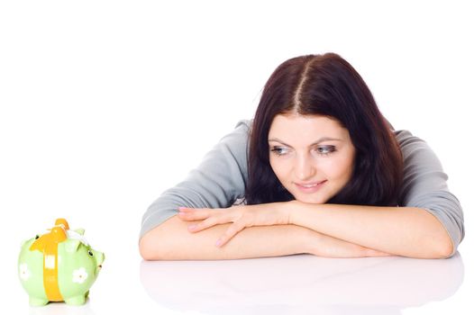 Woman looking on piggy bank, isolated on white.