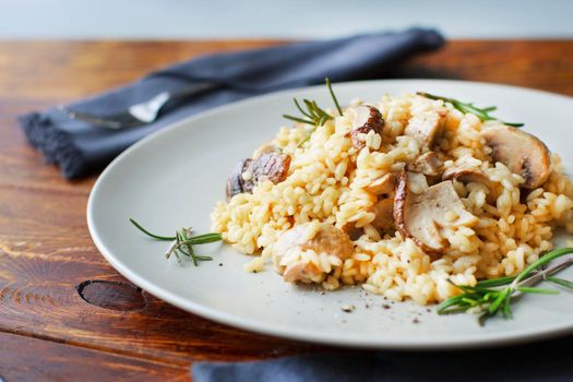 delicious rice with mushrooms and green rosemary, risotto