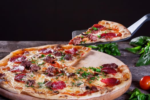 Pepperoni Pizza with salami, mushrooms , meat , beef, cheese and green onions on the wooden background. Top view.